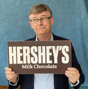 Todd Hunt holding a large Hershey bar.